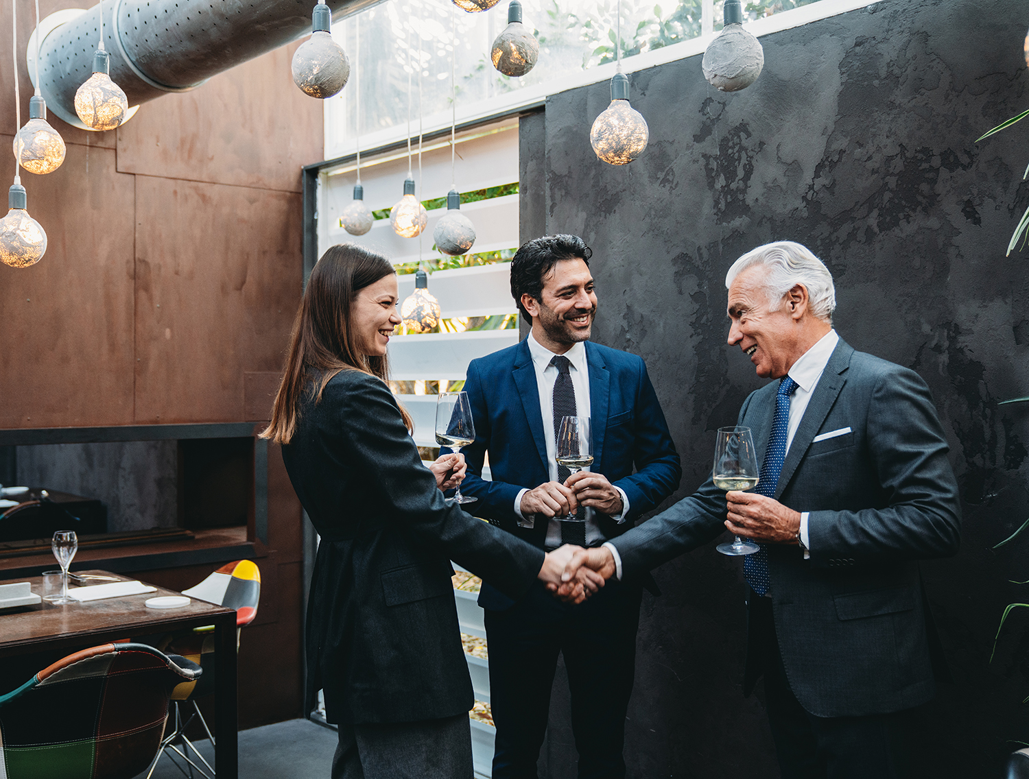 Business meeting in a restaurant. People are greeting each other. High-end luxury restaurant.