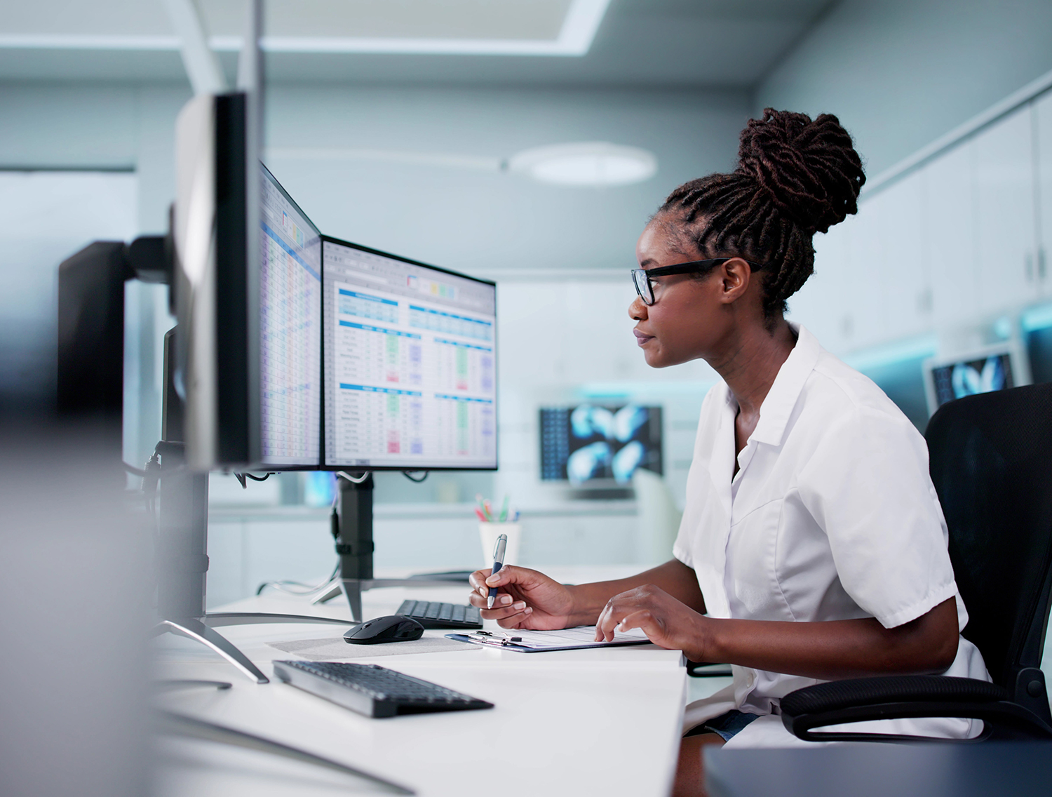 Hospital Doctor Using Spreadsheet For Billing Codes On Desktop